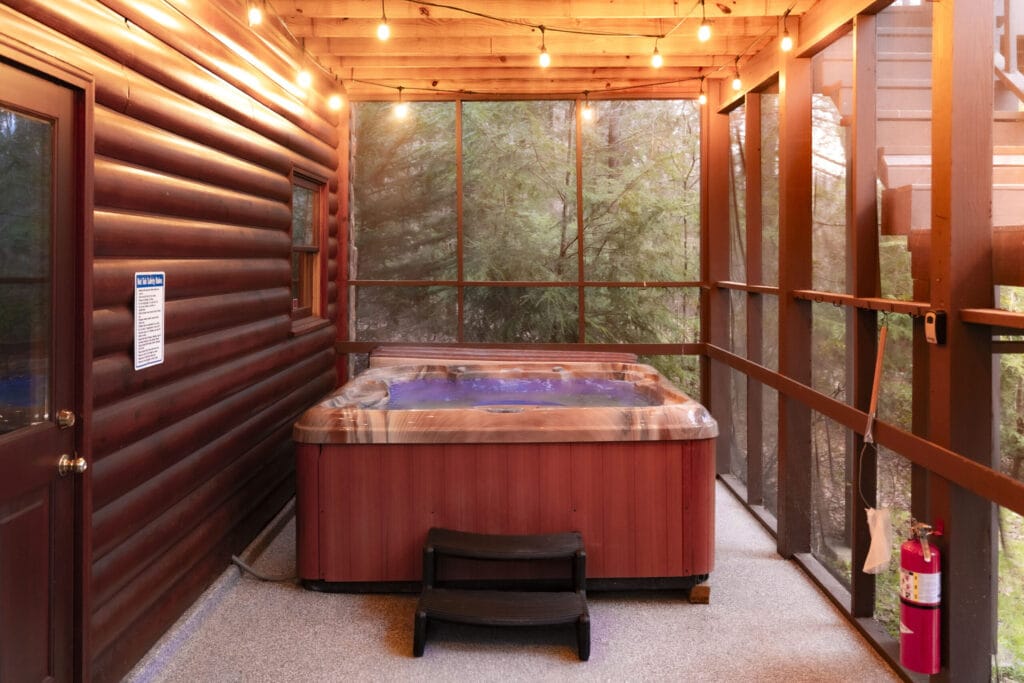 Sunroom with a hot tup and string lighting on the ceiling